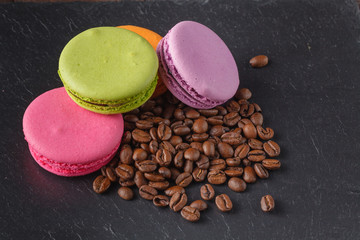 Colorfull macaroons with roasted coffee beans