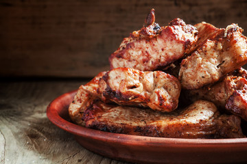 Grilled meats, hot pieces on a clay dish, selective focus