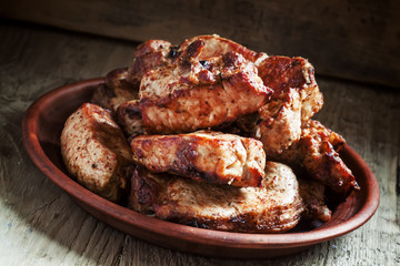 Grilled meats, hot pieces on a clay dish, selective focus