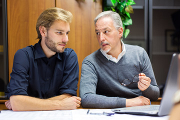 Two employees at work in an office