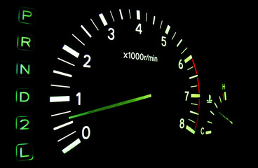 The tachometer on the instrument panel in the car