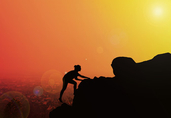 Women silhouette hiking on cliff with blurred twilight city topv