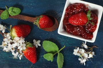 fresh strawberries on the blue wooden background