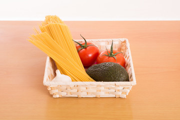 Fresh tomatoes, garlic, avocado, and pasta