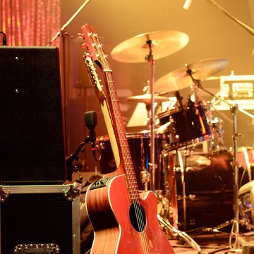 Guitar and other musical equipment on stage before concert