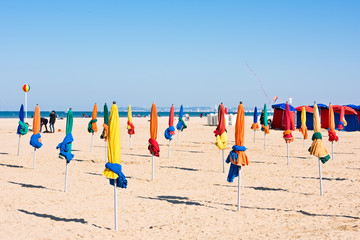 The famous colorful parasols on Deauville beach - obrazy, fototapety, plakaty