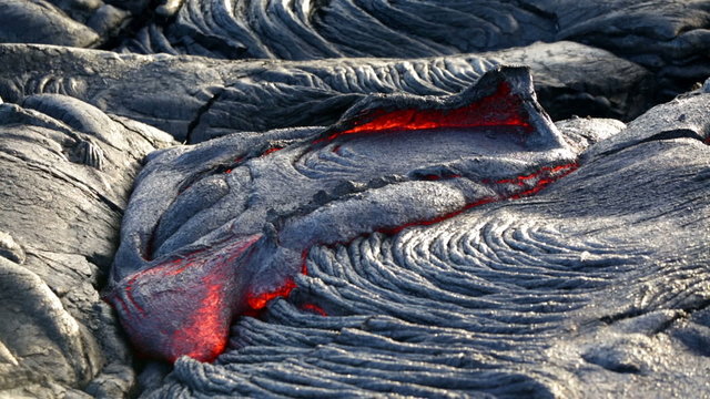 Lava - flowing lava from Kilauea volcano, Big Island, Hawaii. Lava stream flowing in real-time from Kilauea volcano around Hawaii volcanoes national park, USA.