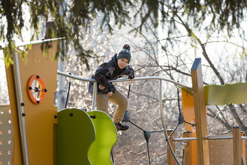 Teenager on the playground on a sunny day in early spring