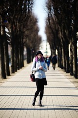 Stylish, young and beautiful girl with color hair poses on streets of St. Petersburg