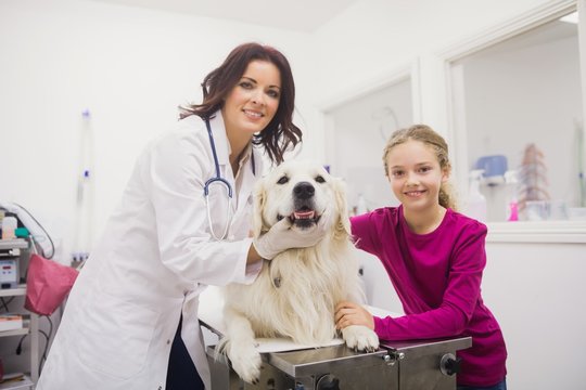 Portrait of girl and vet with dog