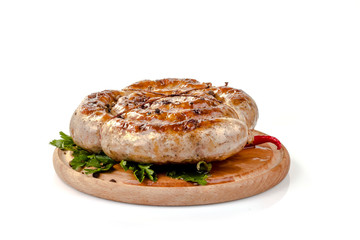 fried pork sausages on a barbecue on a wooden plate with cherry tomatoes and hot peppers