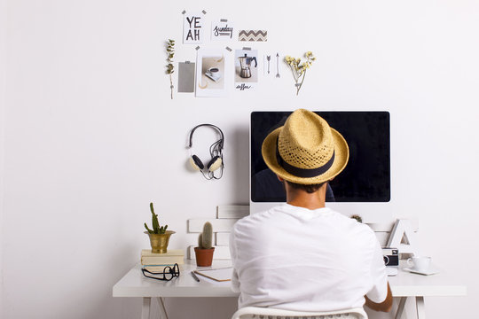 Man at desk in white workroom