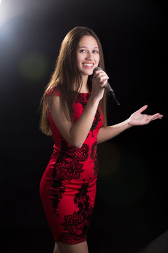 Young female speaker in red dress