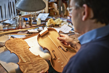 Violin maker at work in his workshop