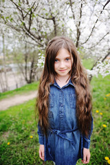 Fototapeta premium Kid girl in blooming garden