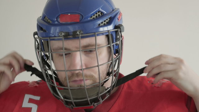 Young Ice Hockey Player Portrait wearing Helmet on White Backgroud