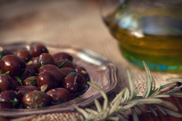 Plate of black olives with olive oil 