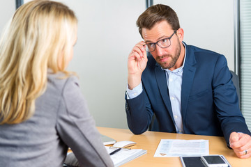 Young attractive employer doing a job interview to a woman
