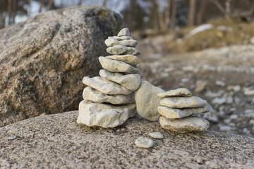 Stack of round smooth stones on a big stone