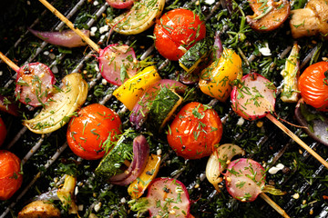 Grilled veggie skewers with cherry tomatoes, radishes, peppers and onions with fresh dill on a...