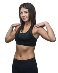 Fototapeta na wymiar A young pretty girl with brown eyes in sportswear doing exercises on a white background