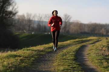 Young female runner in evening sun