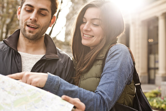 Germany, Cologne, young couple watching city map