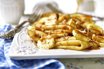 Pancakes with banana,caramel,nuts and cinnamon.