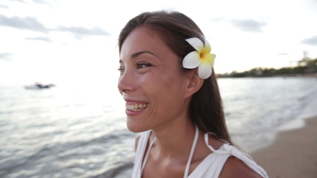 Woman happy on beach Big Island, Hawaii. Travel vacation holidays concept with beautiful smiling cheerful multiracial girl walking on Hawaiian Waikoloa beach in USA. Mixed race Asian Caucasian female.