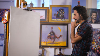 The artist thinks about the story of the picture. Clean canvas on a stretcher.