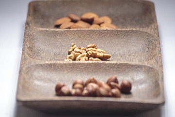 Isolated dried nuts and fruits with shallow depth of field
