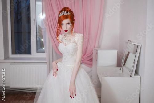  red haired girl in a wedding  dress  bright unusual 