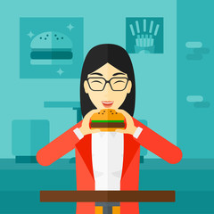 Woman eating hamburger. 