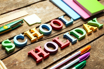 Set of stationery with alphabet on wooden table