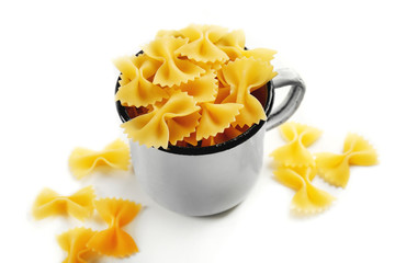 Pile of Italian dry pasta in a cup  isolated on white