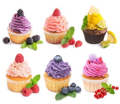 Collection of bright cupcakes with fresh berries isolated