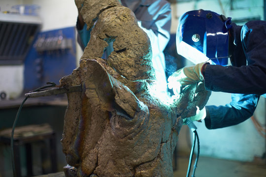 South Africa, Cape Town, Art foundry worker welding cast parts