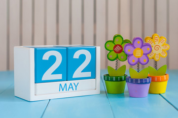 May 22nd. Image of may 22 wooden color calendar on white background with flower. Spring day, empty space for text