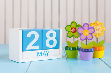 May 28th. Image of may 28 wooden color calendar on white background with flowers. Spring day, empty space for text