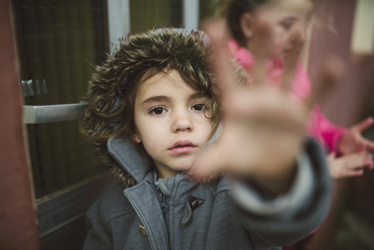 Portrait of little girl showing stop gesture