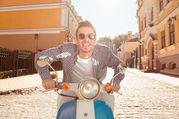 Handsome young man riding a motorbike