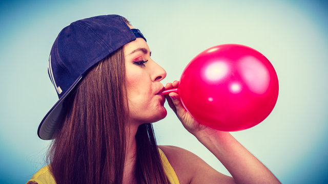 Teen Girl Blowing Red Balloon.