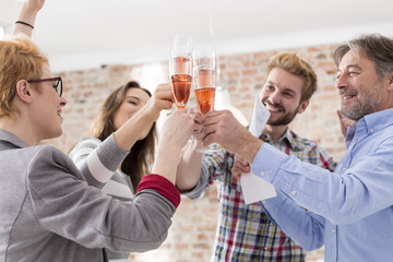 Happy businesspeople toasting with champagne glasses
