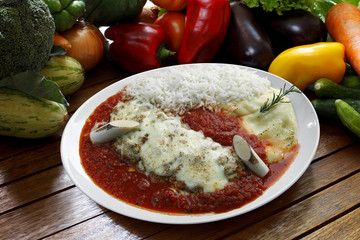 The steak parmigiana with potato and rice