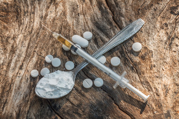selective focus syringe,drug, on wood background.