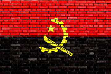flag of Angola painted on brick wall