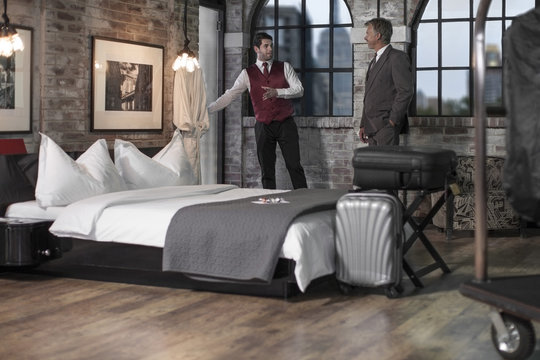 Man in hotel room with bellboy