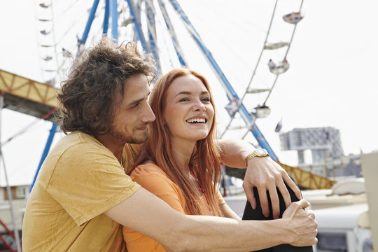 Happy young couple on a funfair