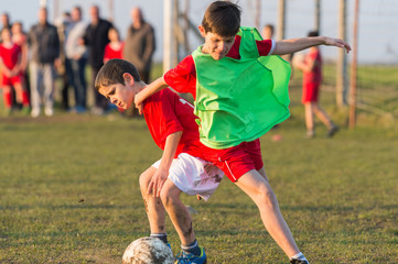 boys kicking football