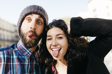 Playful young couple pulling faces